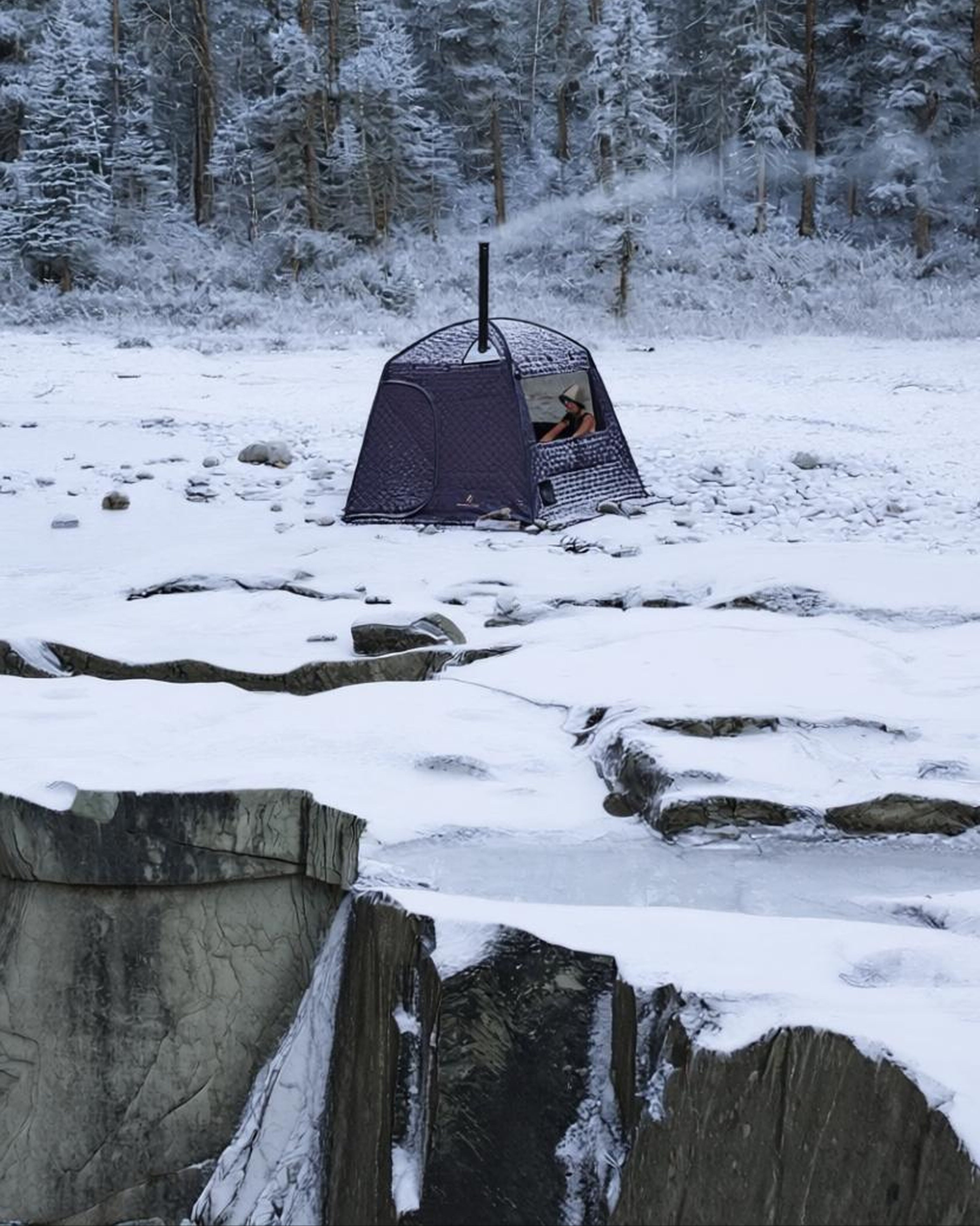 Thermaculture Sauna Tent set up on a snowy landscape with trees in the background in Golden BC, Canada